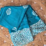 Turquoise Blue Saree with White Floral Motifs & Printed Designer Border