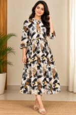 Woman wearing black, mustard and cream abstract printed flared midi dress with three-quarter sleeves.