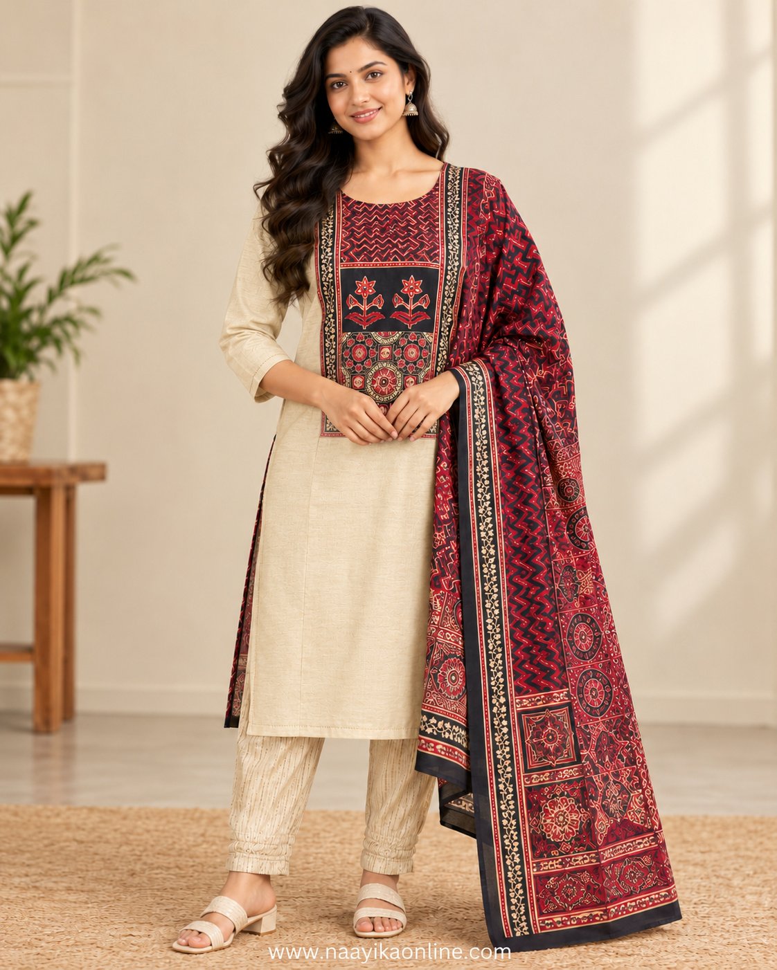 Cream & Black Ajrak Printed Kurta Set with Dupatta | Naayika Online Woman wearing cream straight-cut kurta with black and red printed yoke, cream pants and contrasting Ajrak-style dupatta.